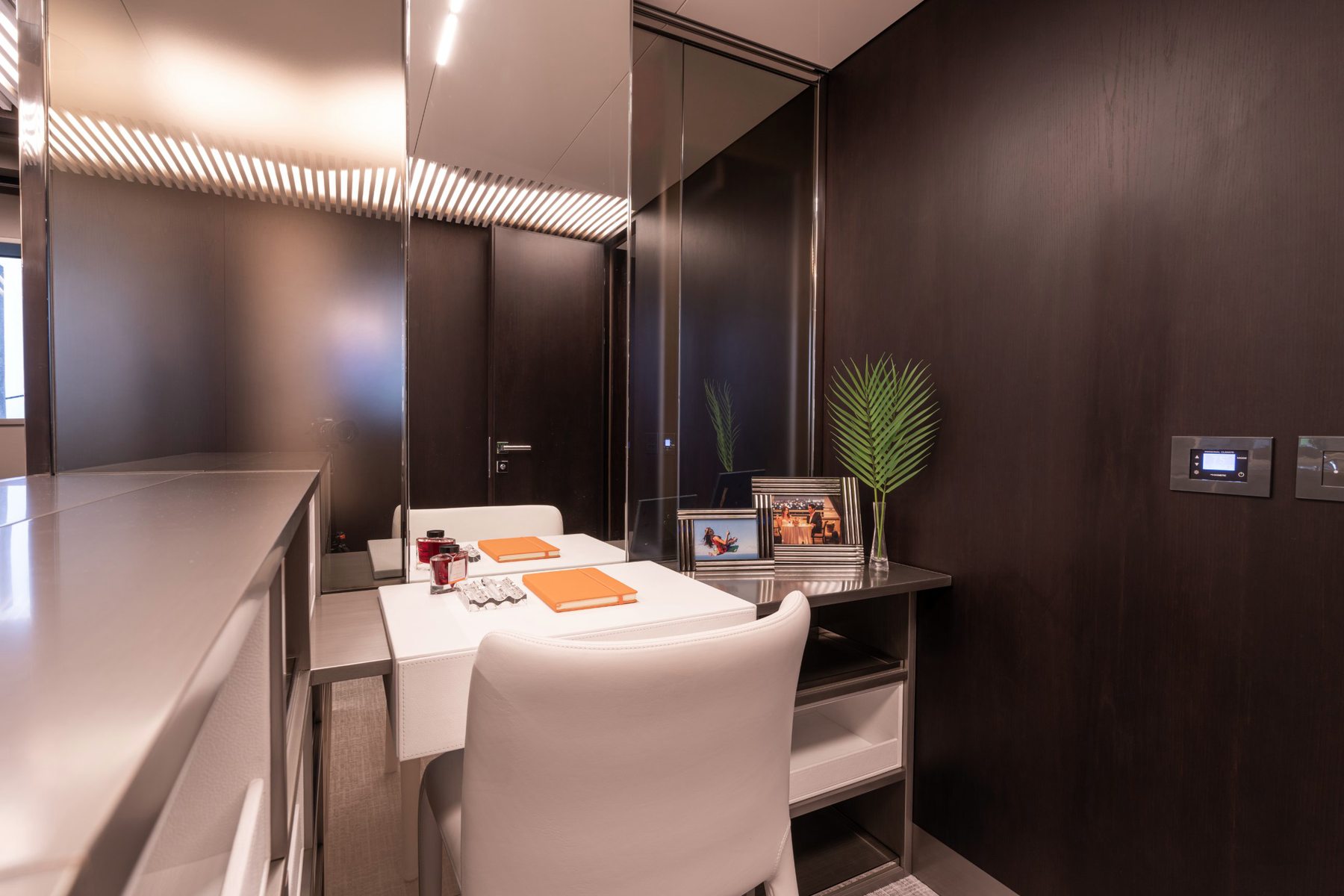 Vanity desk with orange notebooks. Yacht interior by M2Develop, Fort Lauderdale