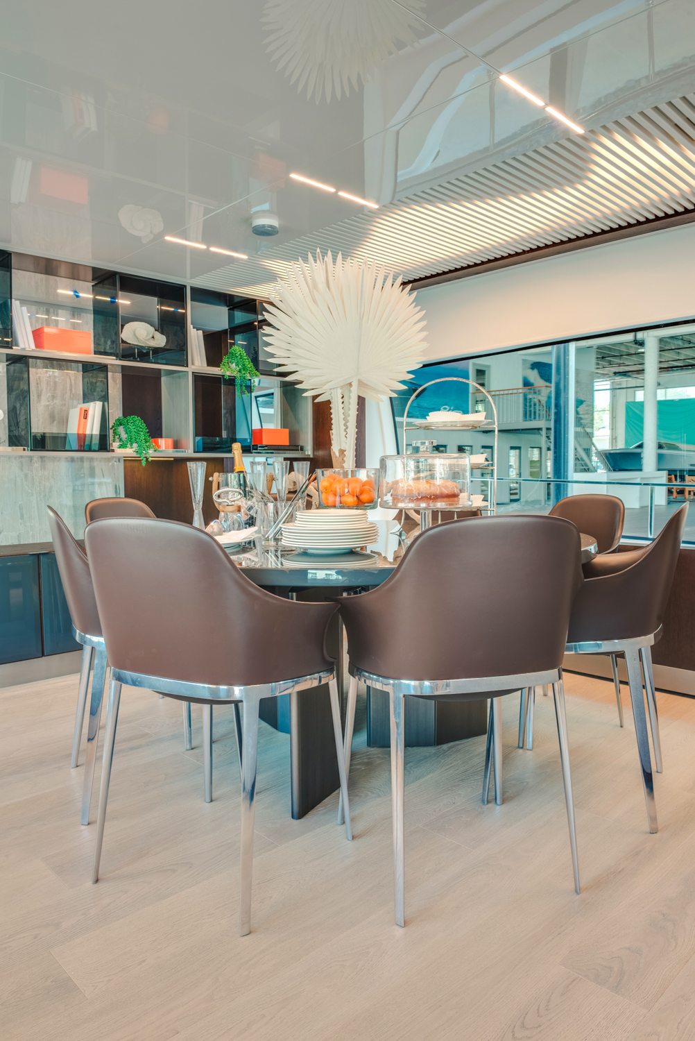 Dining with a palm centerpiece. Yacht interior by M2Develop, Fort Lauderdale